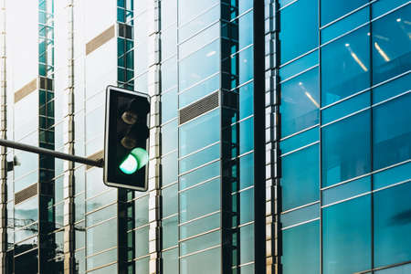 Green light and modern, glass office building - business conceptの写真素材