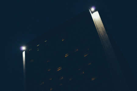 Modern office building at night - business conceptの写真素材