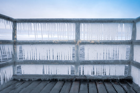 Icicles hanging on footbridge - frost, winter conceptの写真素材