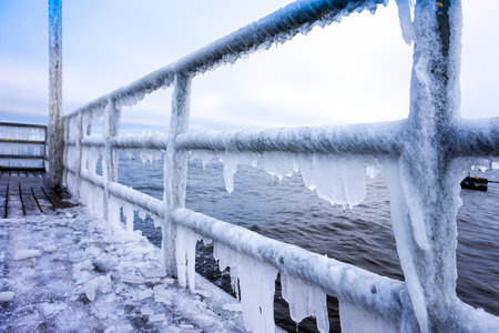 Icicles hanging on footbridge - frost, winter conceptの写真素材