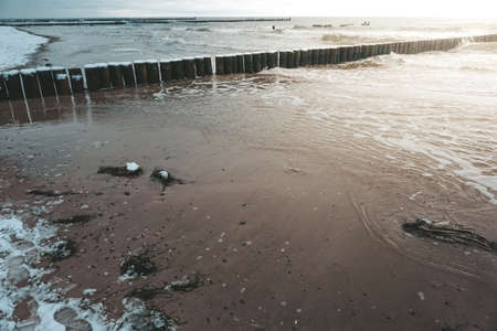 Wooden groyne on a seaの写真素材