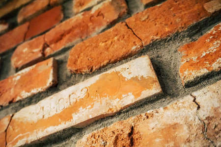 Vintage, cracked bricks with letters on a wallの写真素材