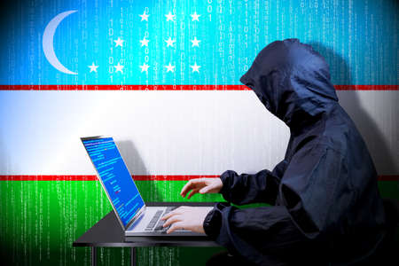 Anonymous hooded hacker, flag of Uzbekistan, binary code - cyber attack conceptの写真素材