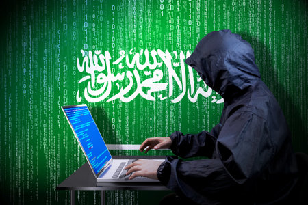 Anonymous hooded hacker, flag of Saudi Arabia, binary code - cyber attack concept