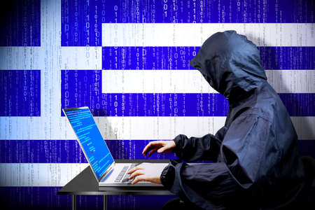 Anonymous hooded hacker, flag of Greece, binary code - cyber attack conceptの写真素材