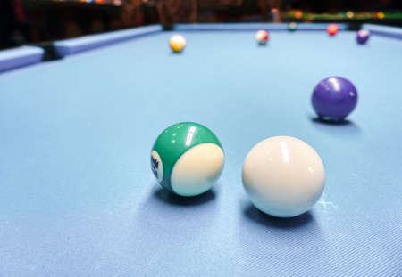 Billiards game - white and colorful balls on a tableの写真素材