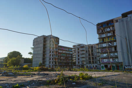 Warsaw, Poland, June 5th 2022 - Unfinished residential building, fence - abandoned real estate...