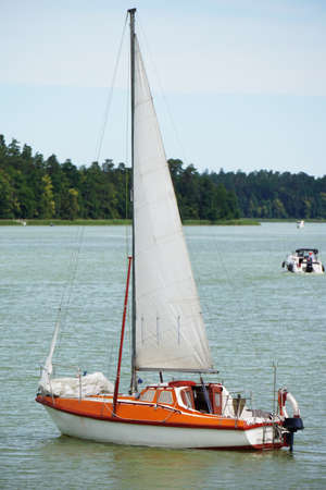 Sailboat swimming with an engine - front view