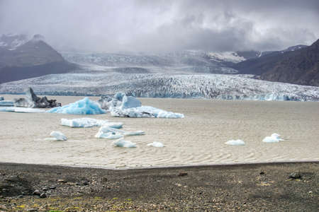Fjallsarlon Iceberg Lagoon in Iceland - glacier, ice floes, mountains and lake shore
