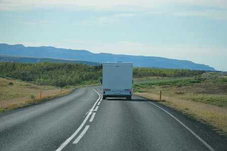 Iceland, Sudurland - August 8th, 2022 - White camper, RV driving on a road - back viewのeditorial素材