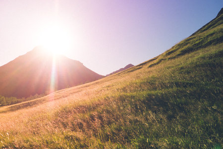 Sunset over mountains, meadow on first plan, Iceland - HDR photographの写真素材