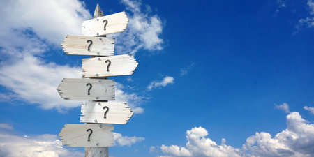 Question marks  - wooden signpost with six arrowsの写真素材