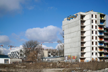 Warsaw, Poland, March 16th 2023 - Unfinished residential building covered with graffiti - abandoned real estate project, bankruptcy conceptのeditorial素材