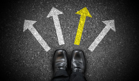 Black business shoes and four chalky arrows on asphalt - choice conceptの写真素材