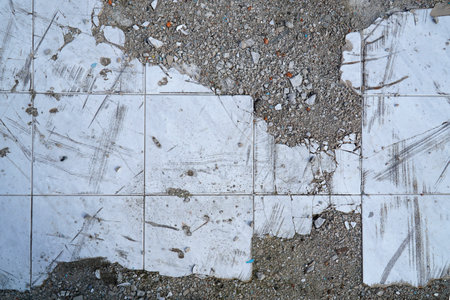 Floor surface with broken white tiles and concreteの写真素材