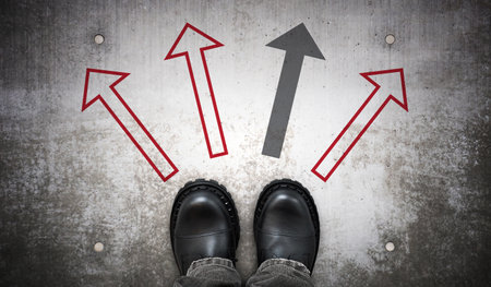 Heavy black leather boots and four arrows on ground - choice concept