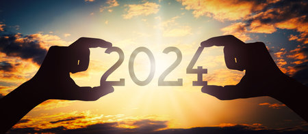 2024 - human hands holding black silhouette year numberの写真素材