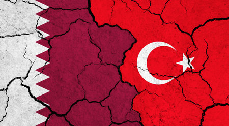 Flags of Qatar and Turkey on cracked surface - politics, relationship conceptの写真素材