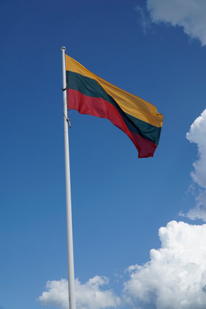 Textile flag of Lithuania and blue sky