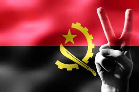 Angola - two fingers showing peace sign and national flagの写真素材