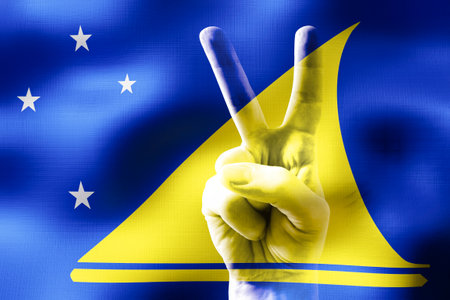 Tokelau - two fingers showing peace sign and national flagの写真素材