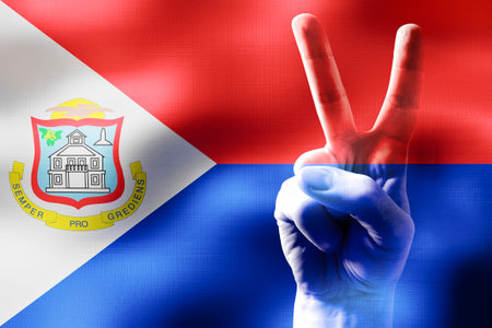 Sint Maarten - two fingers showing peace sign and national flagの写真素材