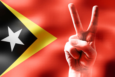 East Timor - two fingers showing peace sign and national flagの写真素材