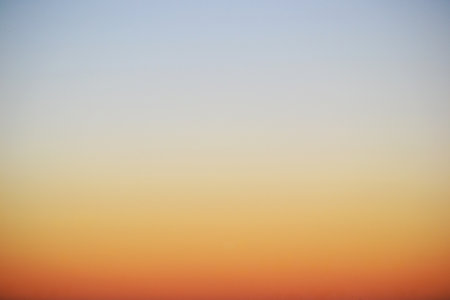 Clear orange and blue sky at sunsetの写真素材