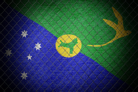 Christmas Island flag and wire mesh fence - 3d illustrationの写真素材