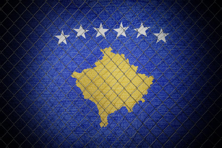 Kosovo flag and wire mesh fence - 3d illustrationの写真素材