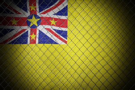 Niue flag and wire mesh fence - 3d illustrationの写真素材