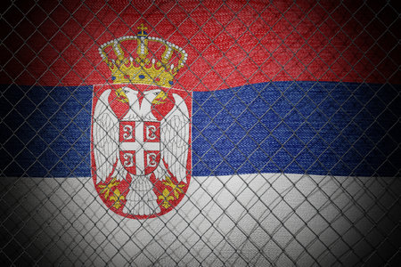 Serbia flag and wire mesh fence - 3d illustrationの写真素材