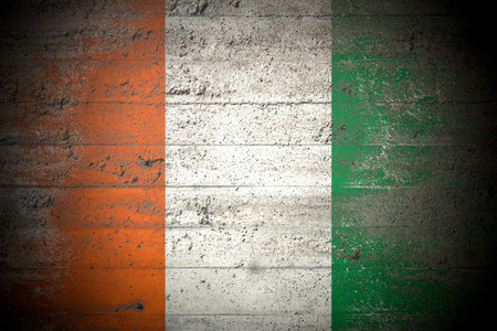 Flag of Ivory Coast on rough concrete wallの写真素材