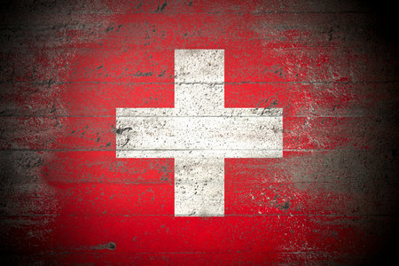 Flag of Switzerland on rough concrete wallの写真素材