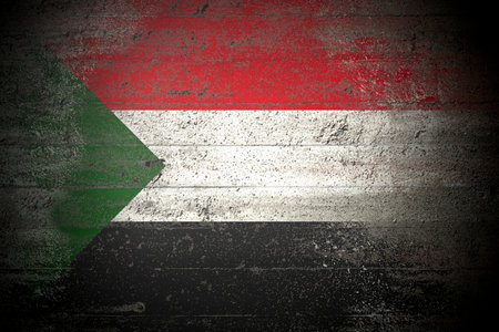 Flag of Sudan on rough concrete wallの写真素材