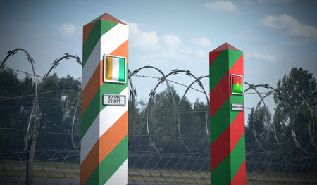 Border posts with flags of Ivory Coast and Burkina Faso - 3d illustrationの写真素材
