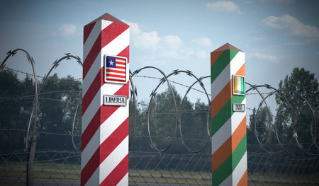Border posts with flags of Liberia and Ivory Coast - 3d illustrationの写真素材