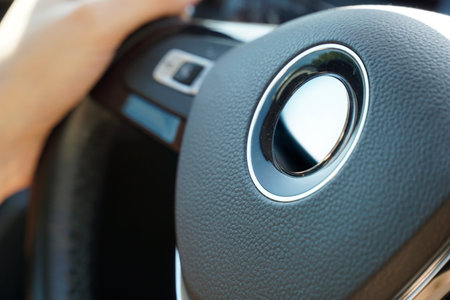 Man Driving Car With Hands On Steering Wheel