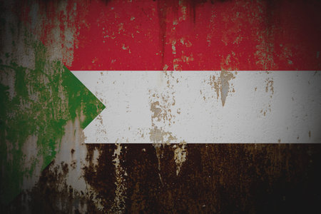 Sudan - Weathered Flag on Old Wall with Peeling Paint and Rustの写真素材