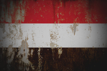 Yemen - Weathered Flag on Old Wall with Peeling Paint and Rust