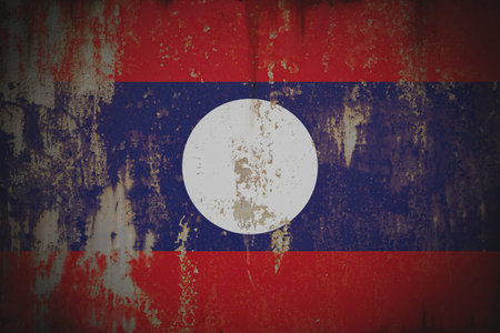 Laos - Weathered Flag on Old Wall with Peeling Paint and Rustの写真素材