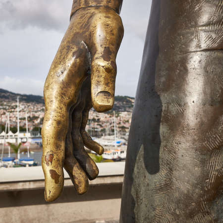 FUNCHAL, MADEIRA, PORTUGAL - MAY 22, 2021: Closeup of hand of bronze statue of Christiano Ronaldo in front of CR7 museum in Funchal, Madeira. Football legend.のeditorial素材