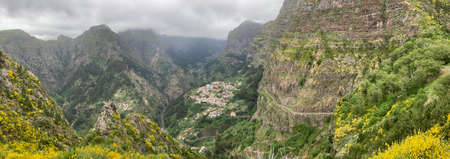 Panorama landscape over Curral das Freiras (Pen of the Nuns). It is a civil parish in the municipality of CÃ¢mara de Lobos in the Portuguese archipelago of Madeira. Village is situated in a deep valley, surrounded by hills.の写真素材