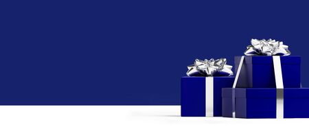 Merry Christmas and Happy New Year web banner. Deep blue gifts box and silver bow ribbon on deep blue background. 3d rendering illustration.の写真素材
