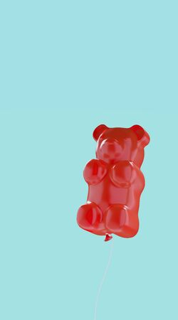 Sweet candies for happiness summer concept. Red jelly bears balloon on light blue background. 3d rendering illustration.の写真素材