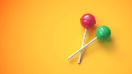 Two sweet lollipops on hot yellow backgroundの写真素材