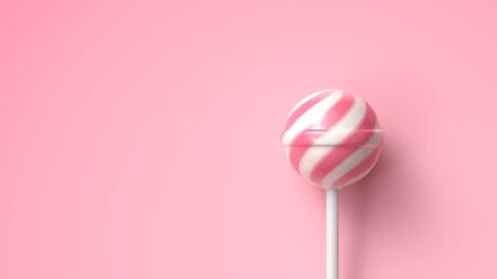 Striped fruit pink and white lollipop on stick on bright pink background with copy spaceの写真素材