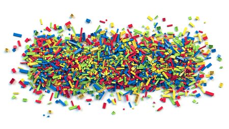 Pile of various colored toy bricks isolated on white background