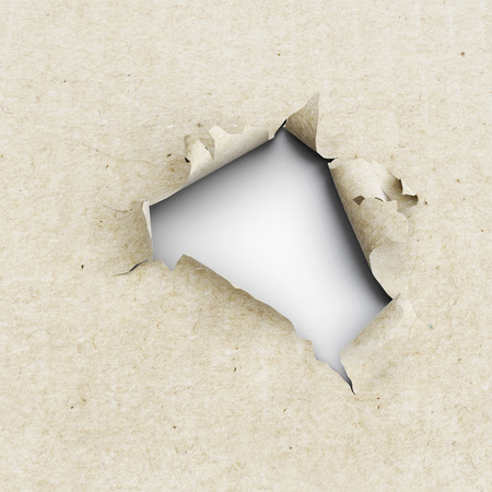 Hole in the kraft paper on a white background. 3d illustration. Torn edges of paper. Close-upの写真素材