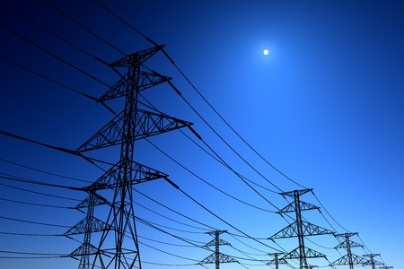 Electricity pylons and lines on a clear blue sky.の写真素材